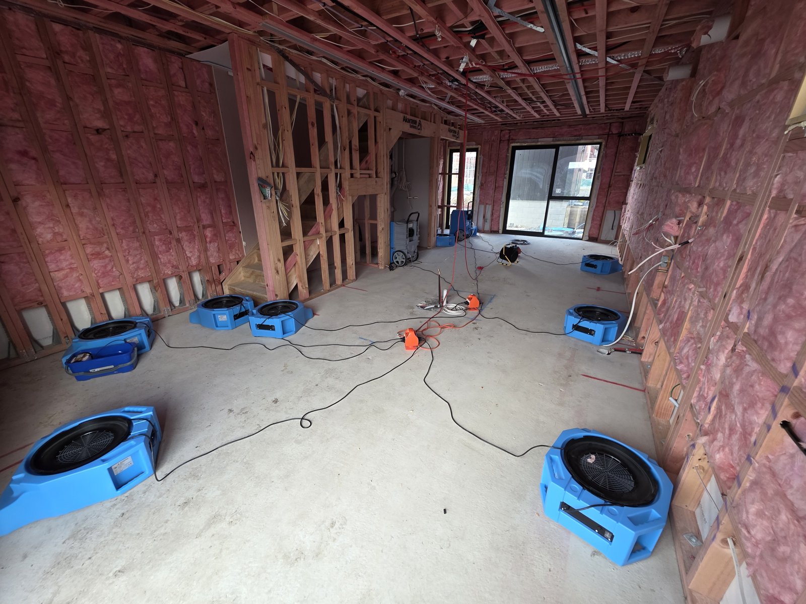 ProDry air movers drying new-build framing rooms with pink insulation